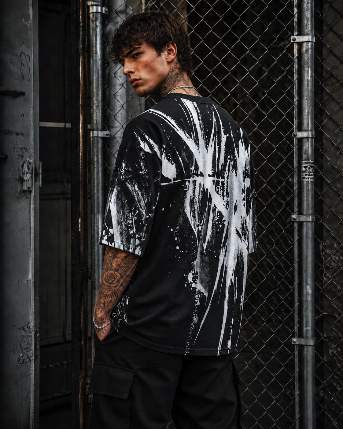 Model Alan wearing the black CALL OF THE BLACK VOID Shirt by Frostbite Apparel in a dark, underground streetwear aesthetic.