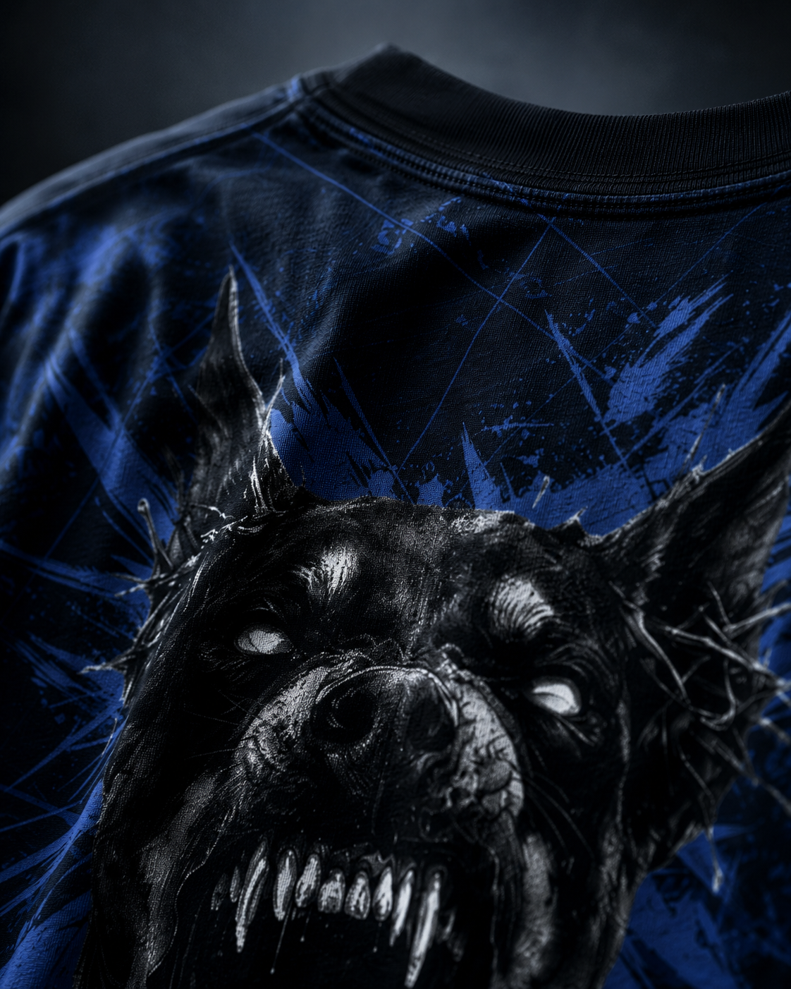 Cinematic detail shot of the FROSTBITE HOUND Shirt with scratched blue textures, barbed graphics, and a cold Frostbite Apparel atmosphere.